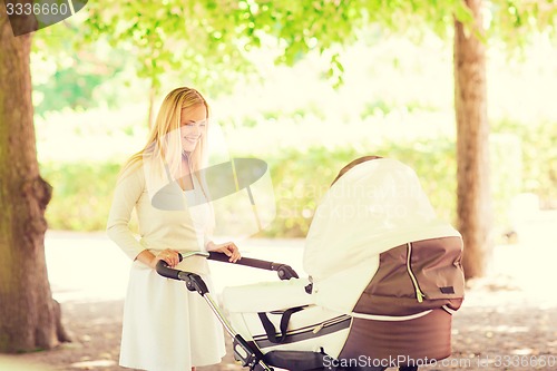 Image of happy mother with stroller in park