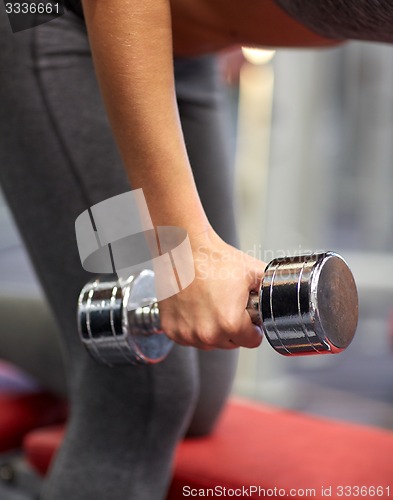 Image of close up of couple with dumbbell exercising in gym