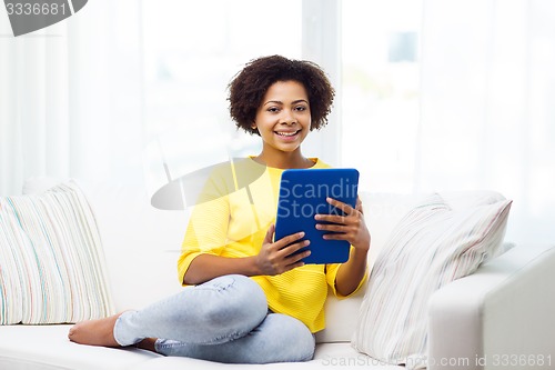 Image of happy african american woman with tablet pc