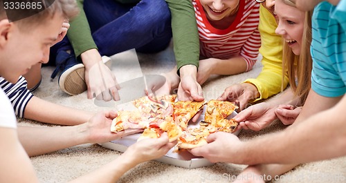 Image of close up of happy friends eating pizza at home