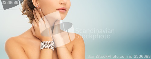 Image of beautiful woman with pearl earrings and bracelet