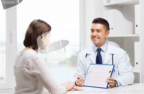 Image of smiling doctor and young woman meeting at hospital