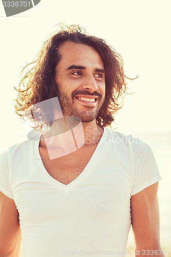 Image of smiling man in white blank shirt outdoors