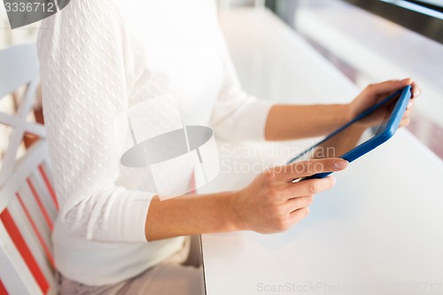 Image of close up of woman with tablet pc at cafe