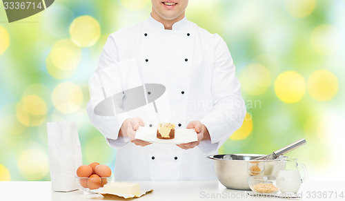 Image of close up of happy male chef cook baking dessert