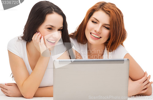 Image of two smiling teenage girls with laptop computer