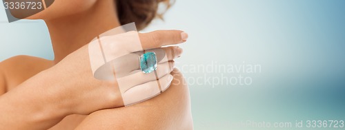 Image of close up of woman with cocktail ring on hand