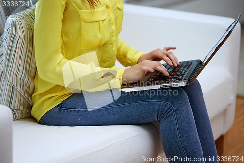 Image of close up of woman with laptop computer at home