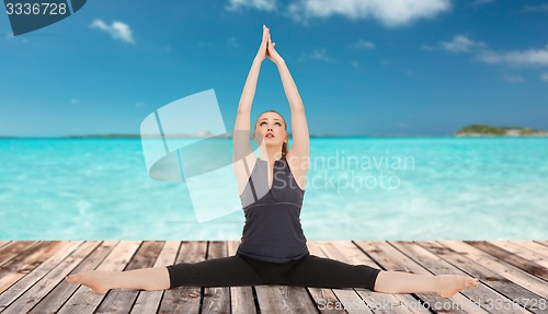 Image of happy young woman doing yoga exerciser