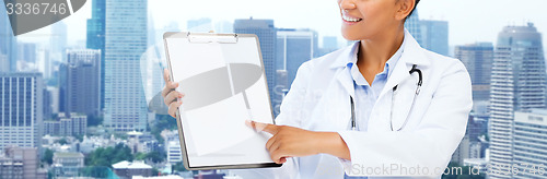 Image of happy african female doctor with clipboard