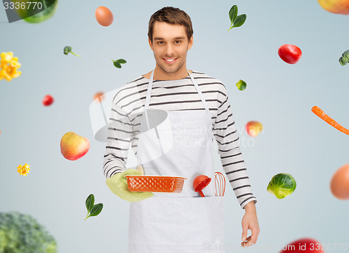 Image of happy man or cook with baking and kitchenware