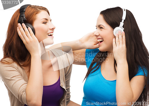Image of two laughing girls with headphones