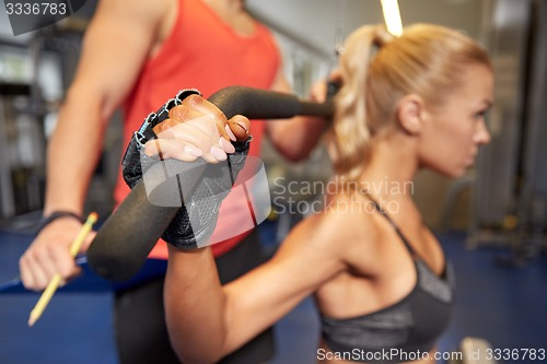 Image of man and woman flexing muscles on gym machine