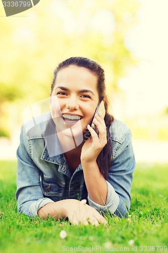Image of laughing young girl lying on grass