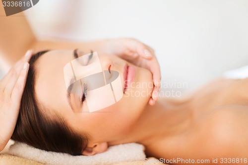 Image of beautiful woman in spa salon having facial