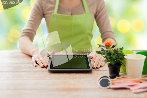 Image of close up of woman or gardener with tablet pc