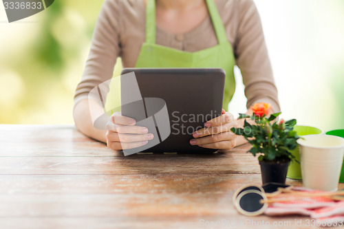 Image of close up of woman or gardener holding tablet pc