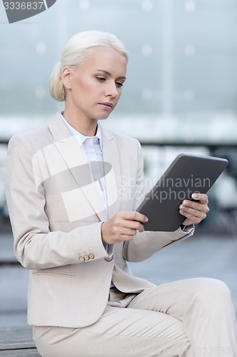 Image of businesswoman working with tablet pc outdoors