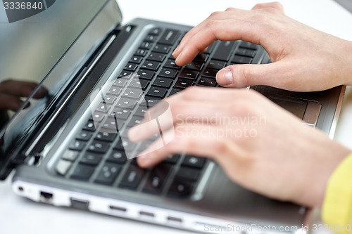 Image of close up of woman with laptop computer in office