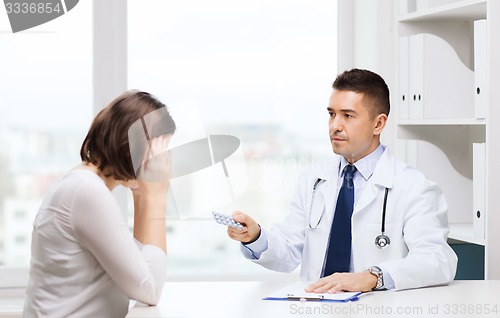 Image of doctor giving pills to woman at hospital