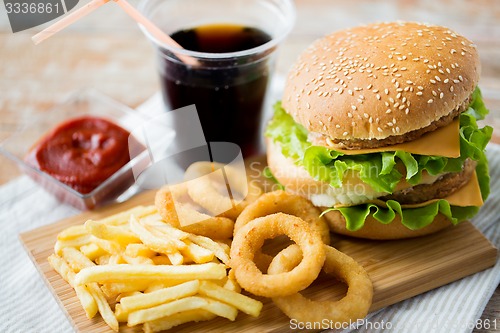 Image of close up of fast food snacks and drink on table