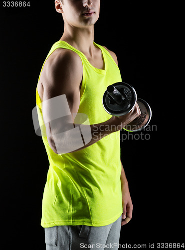 Image of young man with dumbbell