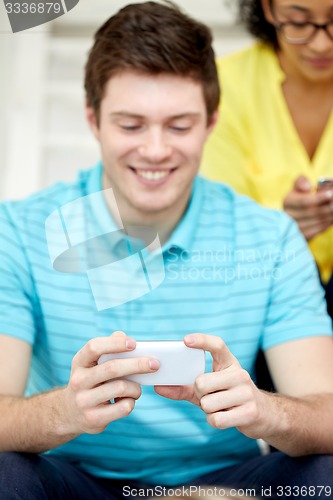Image of close up of young man with smartphone