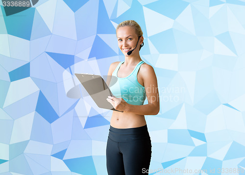 Image of happy woman trainer with microphone and clipboard