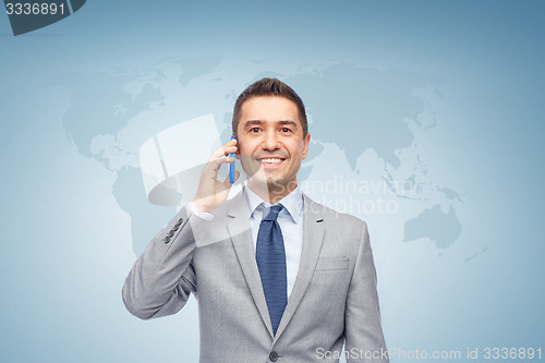 Image of happy businessman calling on smartphone