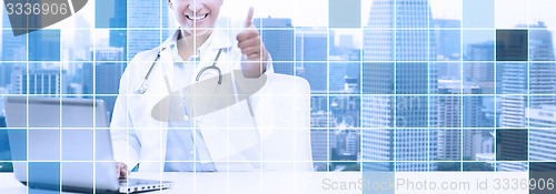 Image of african female doctor with laptop shows thumbs up