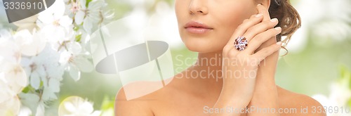 Image of close up of woman with cocktail ring on hand