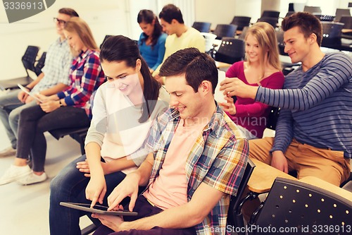 Image of group of smiling students with tablet pc