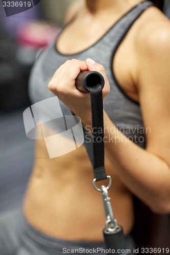 Image of close up of woman exercising on gym machine