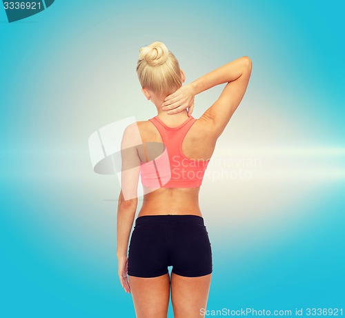 Image of sporty woman touching her neck