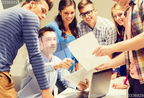 Image of group of students and teacher with laptop