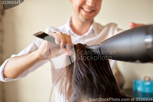 Image of  close up of stylist making hairdo at salon