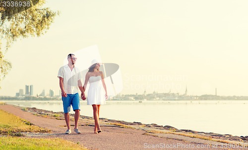 Image of smiling couple walking outdoors