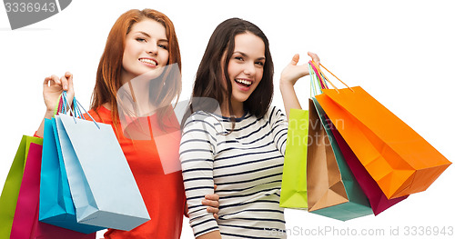 Image of two smiling teenage girls with shopping bags