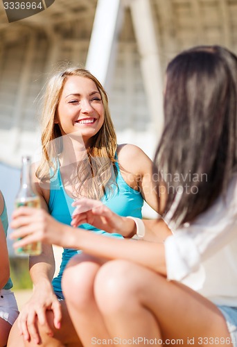 Image of girls with drinks on the beach