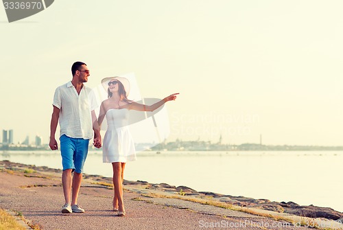 Image of smiling couple walking outdoors