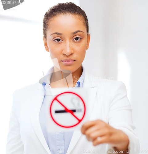 Image of african woman with restriction no smoking sign