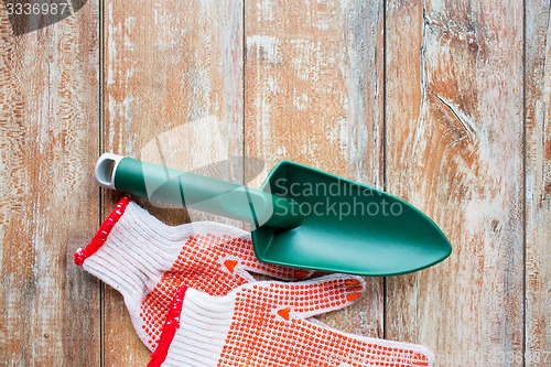 Image of close up of trowel and garden gloves
