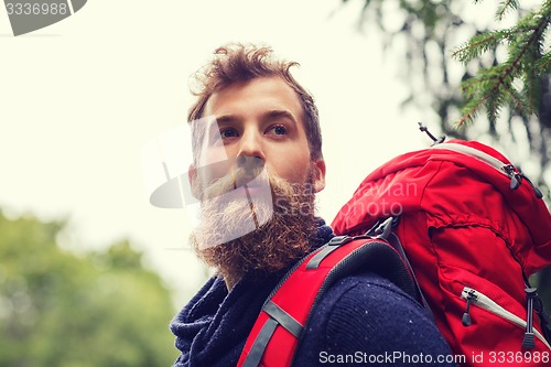 Image of man with beard and backpack hiking