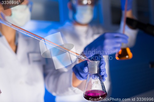 Image of close up of scientists making test in lab