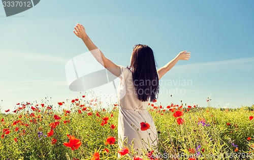 Image of young woman on poppy field