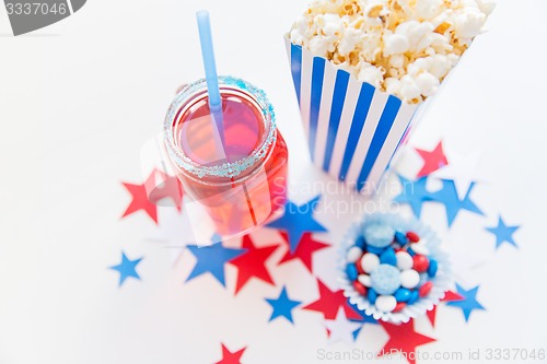 Image of drink and popcorn with candies on independence day