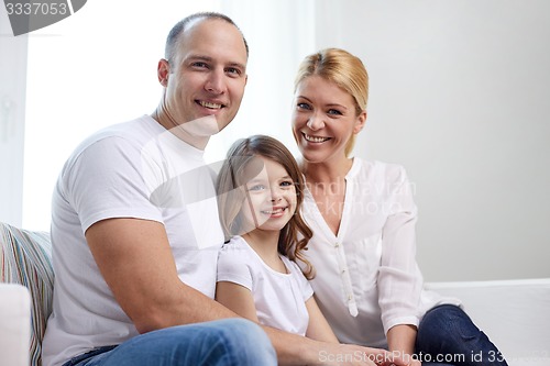 Image of happy parents with little daughter at home