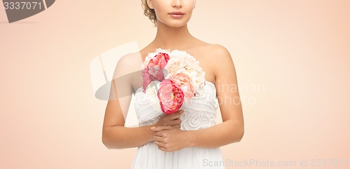 Image of bride or woman with bouquet of flowers