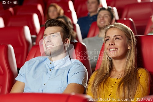 Image of happy friends watching movie in theater