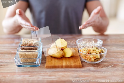 Image of close up of male hands with carbohydrate food